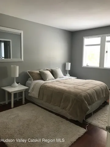 a bedroom with a bed and window