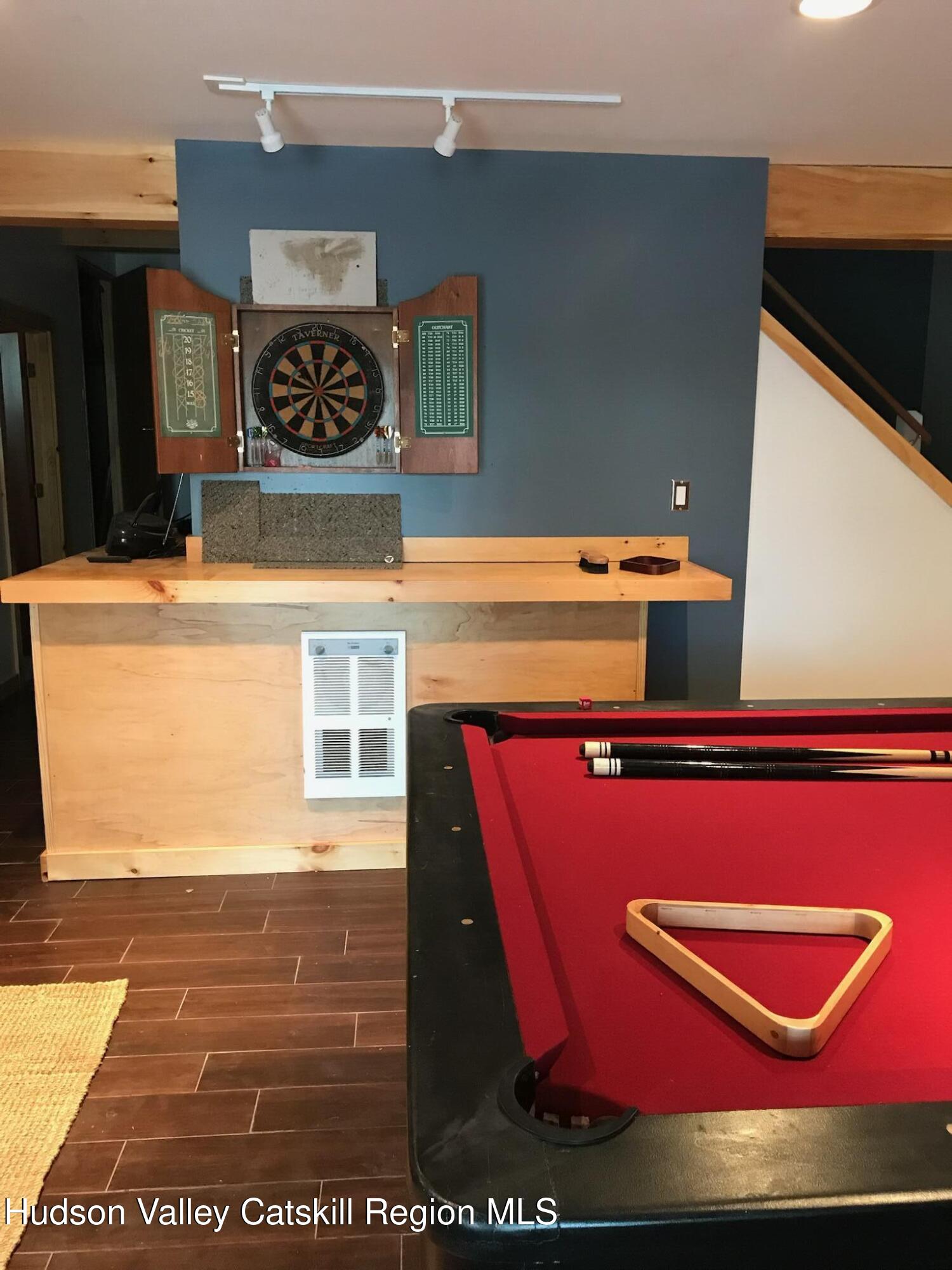 270 Pines Drive, Unit 92 Roxbury, NY 12421 - Photo 21 of 31 a view of a red car park in front of a building