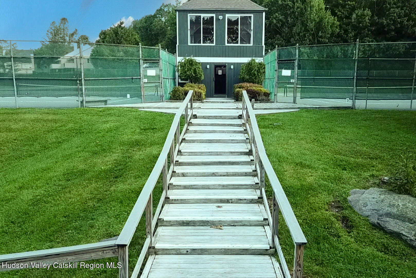 270 Pines Drive, Unit 92 Roxbury, NY 12421 - Photo 29 of 31 a front view of a house with a yard table and chairs