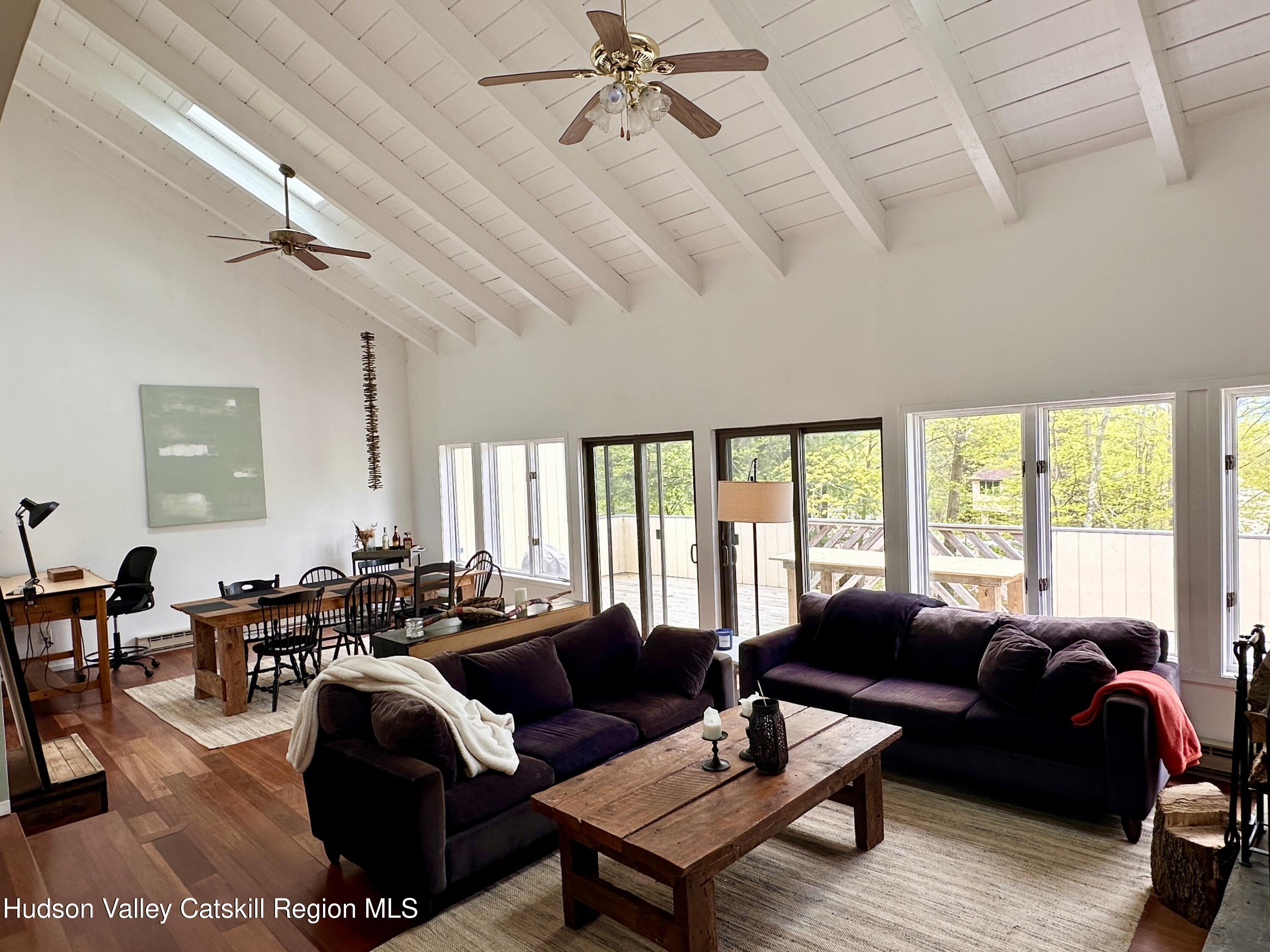 270 Pines Drive, Unit 92 Roxbury, NY 12421 - Photo 3 of 31 a living room with furniture and a large window
