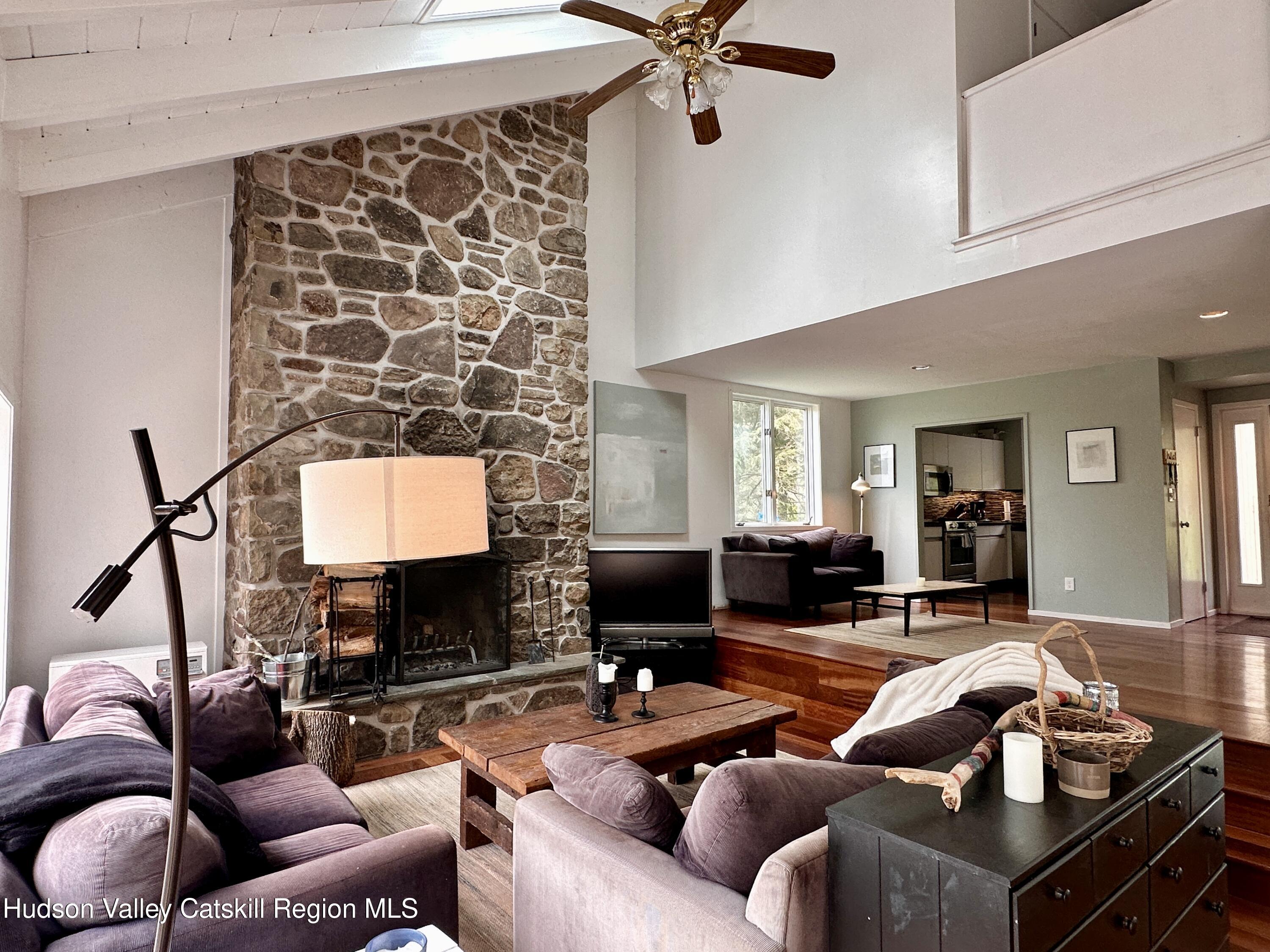 270 Pines Drive, Unit 92 Roxbury, NY 12421 - Photo 4 of 31 a living room with furniture and a fireplace