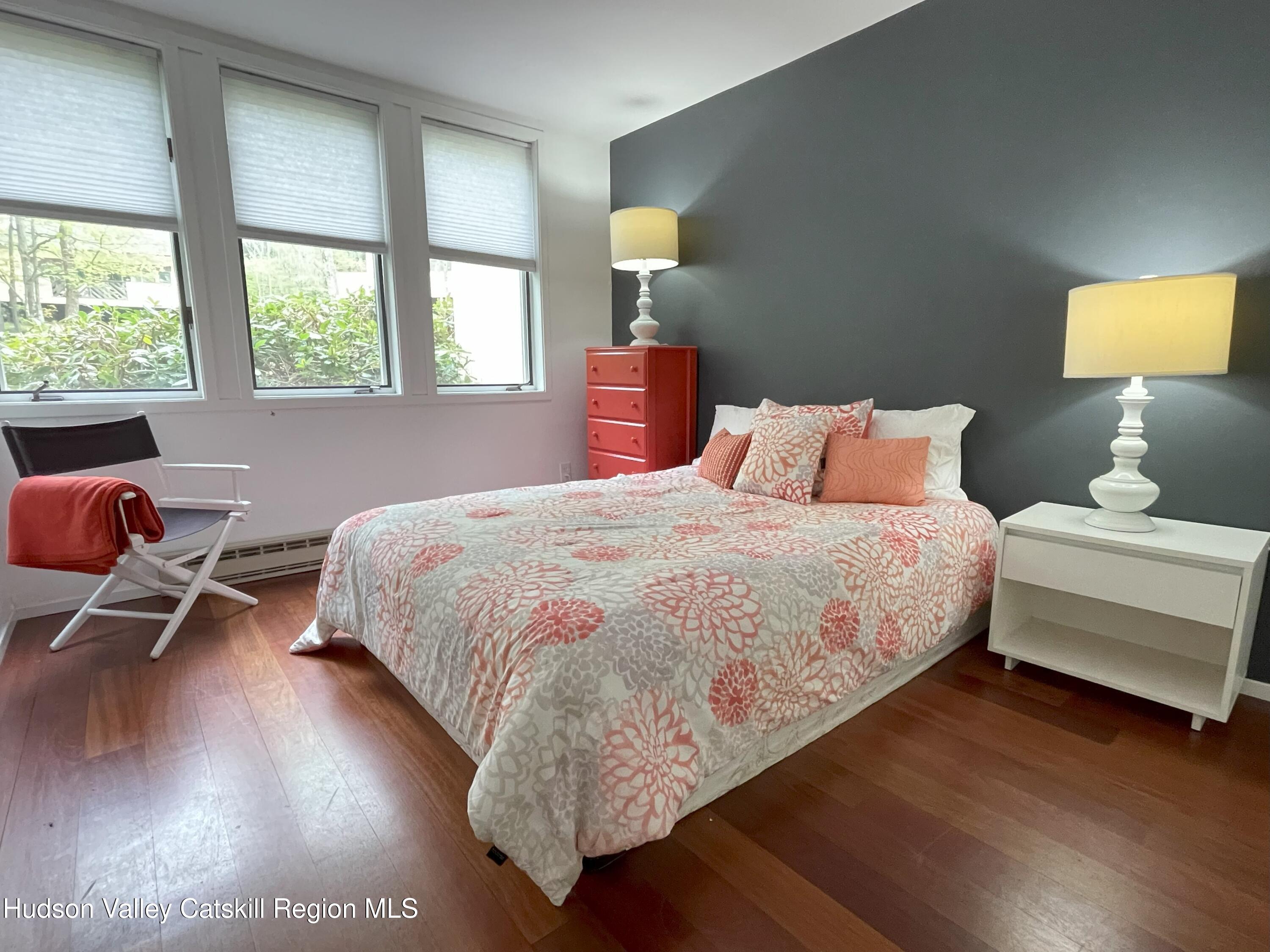 270 Pines Drive, Unit 92 Roxbury, NY 12421 - Photo 9 of 31 a bedroom with a bed and wooden floor