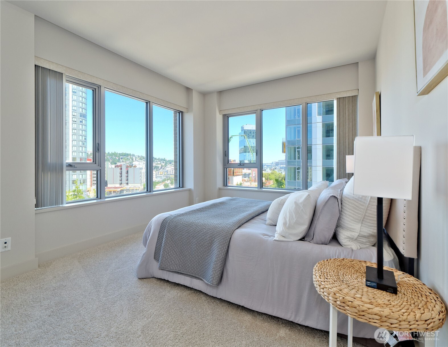 583 Battery Street, Unit 704N Seattle, WA 98121 - Photo 12 of 36 a bedroom with a bed and chair with a large window