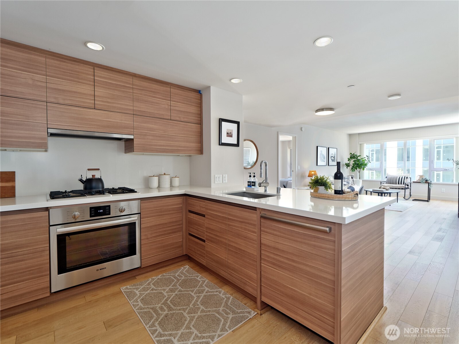 583 Battery Street, Unit 704N Seattle, WA 98121 - Photo 2 of 36 a kitchen with stainless steel appliances granite countertop a stove and a sink