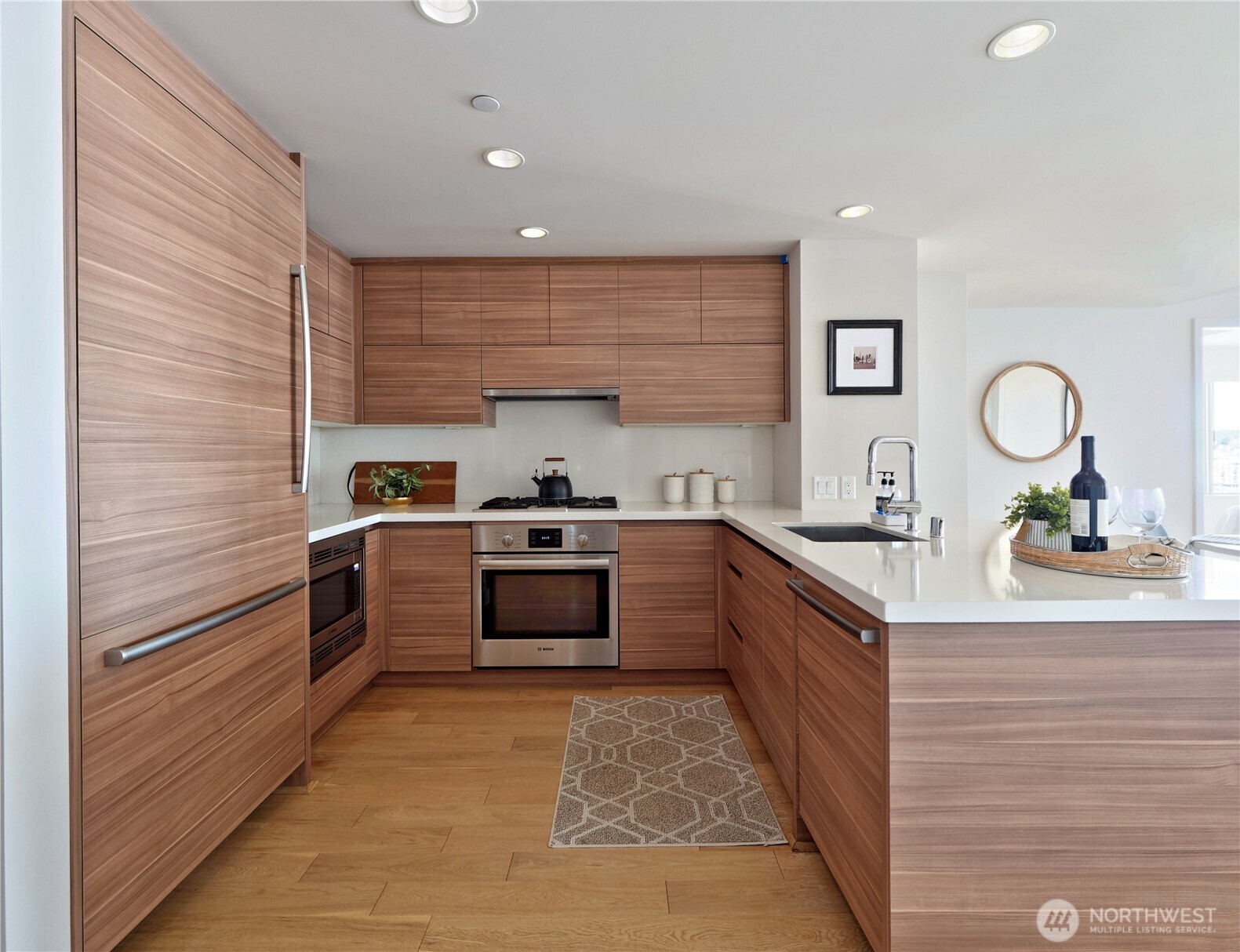 583 Battery Street, Unit 704N Seattle, WA 98121 - Photo 3 of 36 a large kitchen with stainless steel appliances and a sink