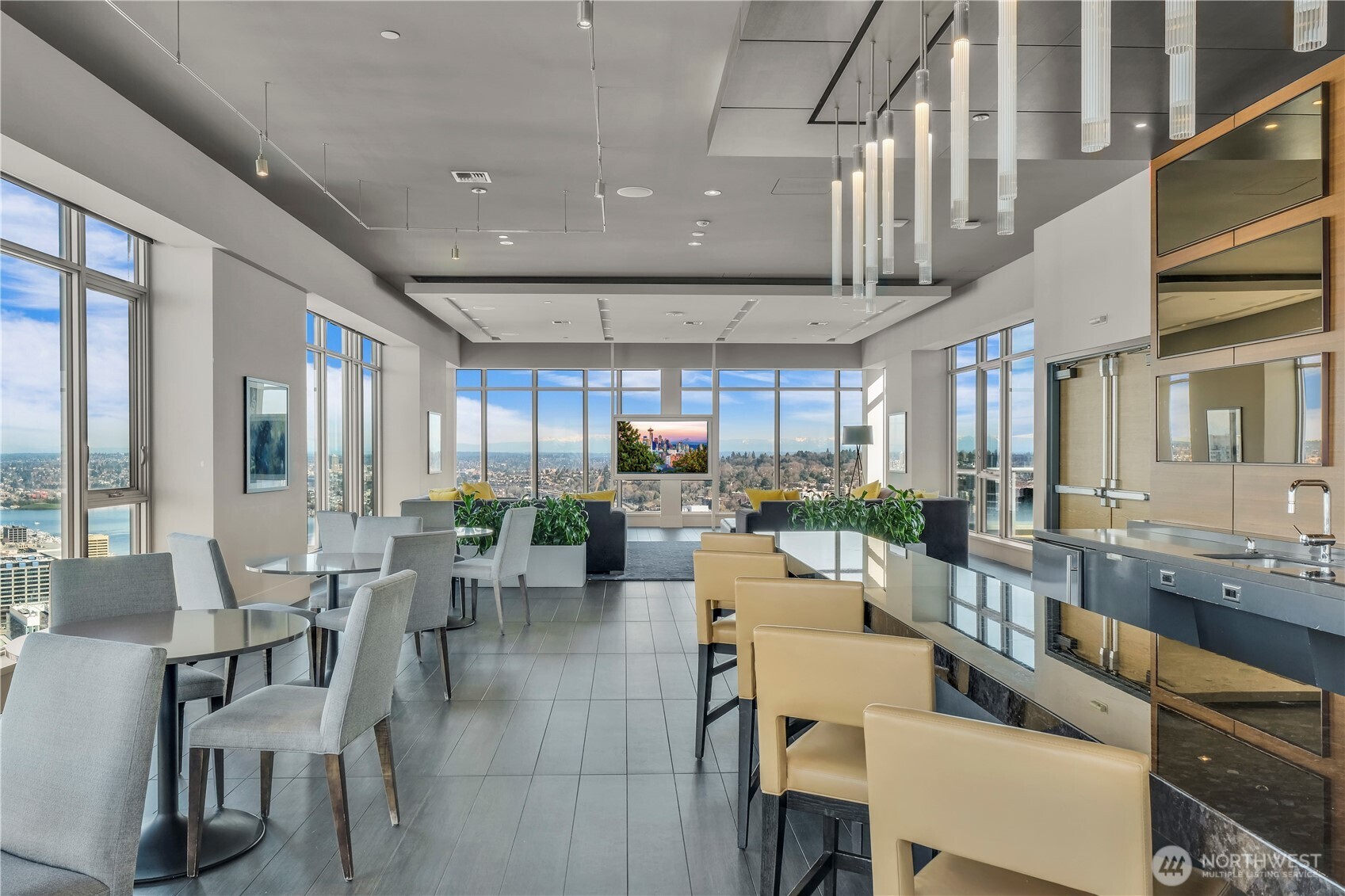 583 Battery Street, Unit 704N Seattle, WA 98121 - Photo 34 of 36 a room with lots of tables a large window and chairs