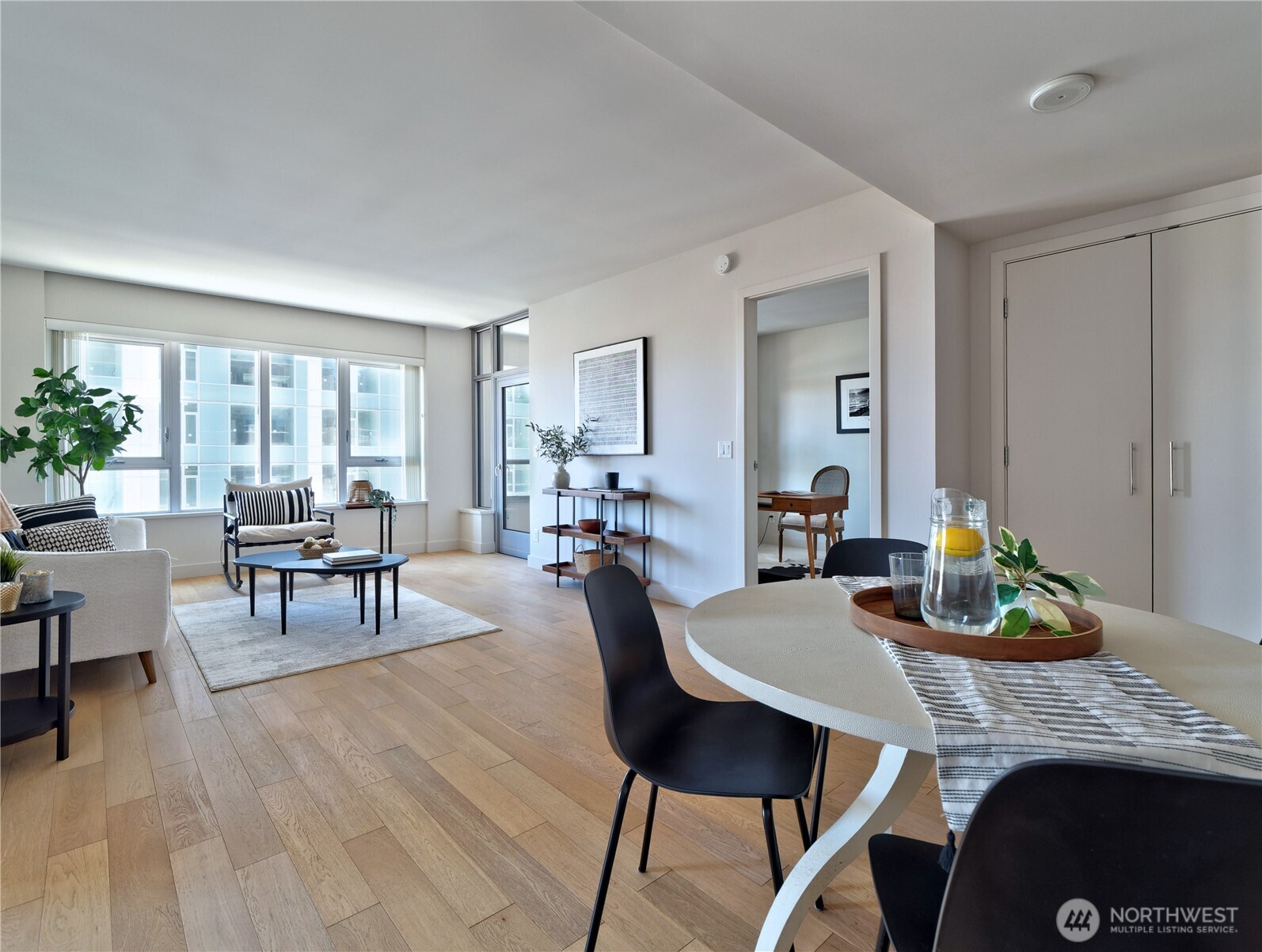 583 Battery Street, Unit 704N Seattle, WA 98121 - Photo 5 of 36 a dining room with furniture and wooden floor