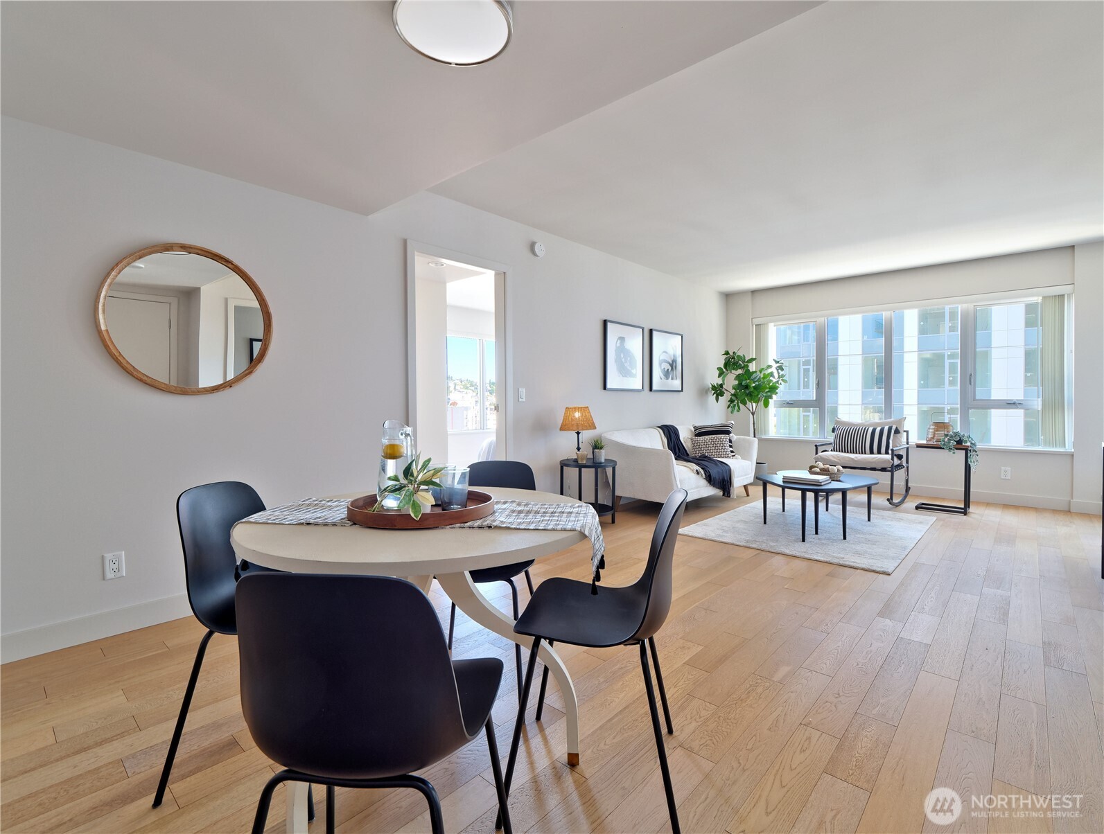 583 Battery Street, Unit 704N Seattle, WA 98121 - Photo 7 of 36 a view of a dining room with furniture and wooden floor