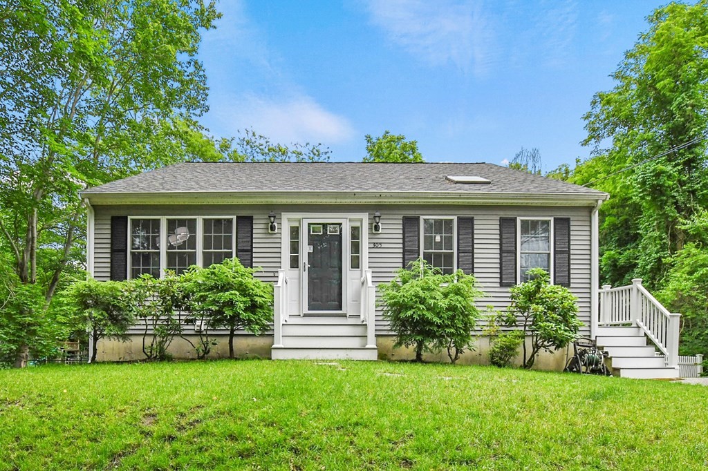 a front view of house with yard and green space