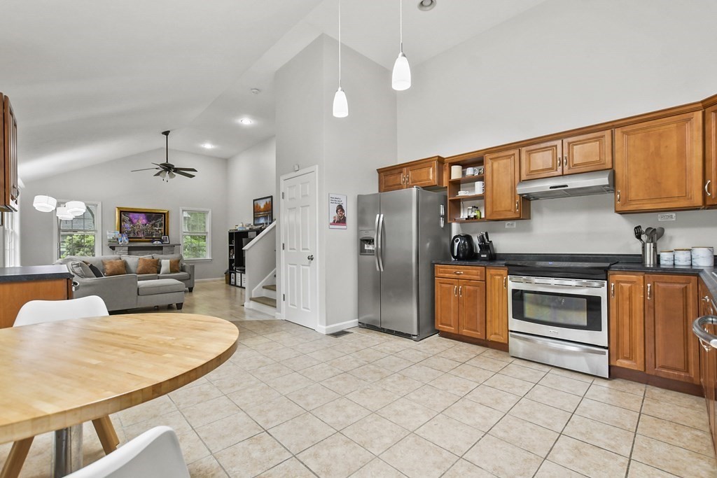 305 North Main Street Raynham, MA 02767 - Photo 11 of 38 a kitchen with stainless steel appliances granite countertop a stove a sink dishwasher and a refrigerator with white cabinets