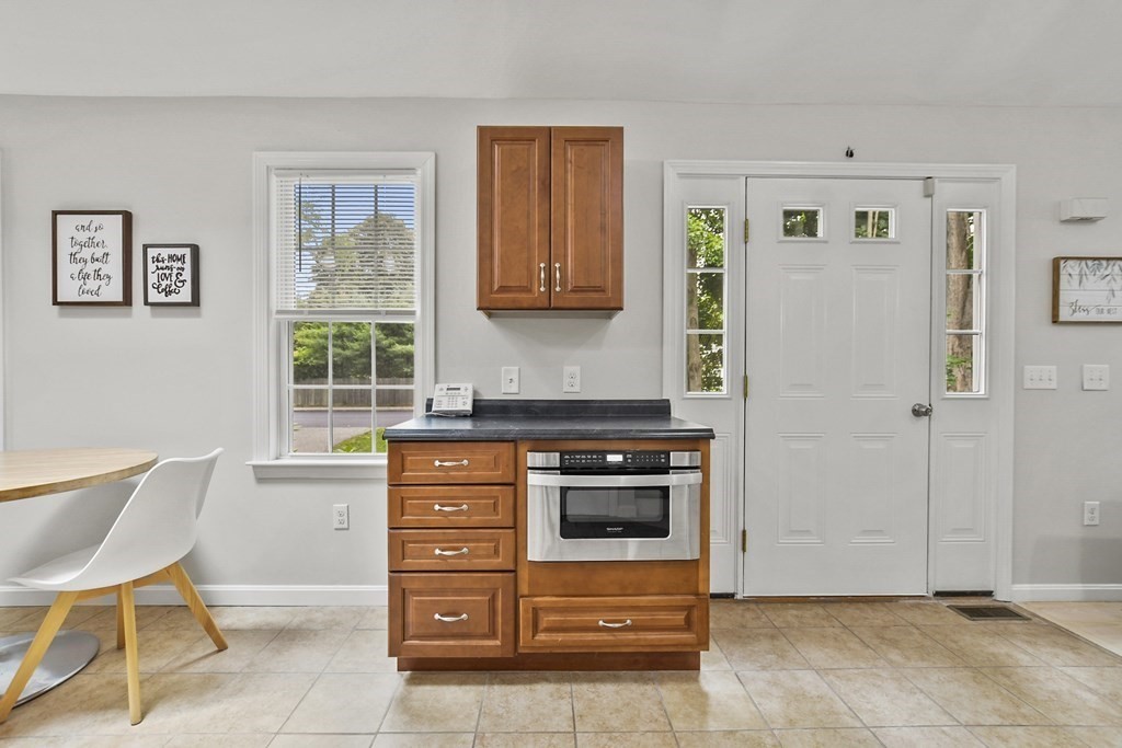 305 North Main Street Raynham, MA 02767 - Photo 12 of 38 a kitchen with stainless steel appliances kitchen island granite countertop a refrigerator and a stove top oven