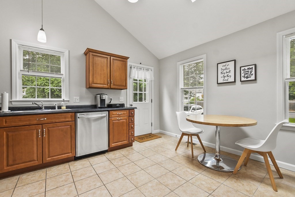 305 North Main Street Raynham, MA 02767 - Photo 14 of 38 a kitchen with granite countertop breakfast area and windows