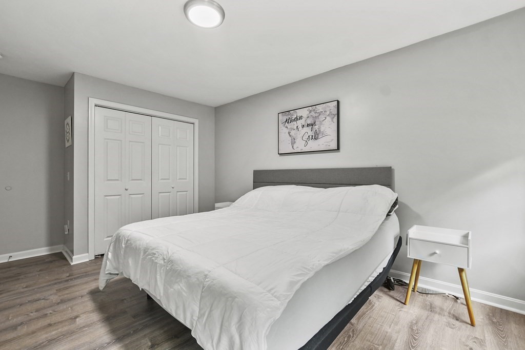 305 North Main Street Raynham, MA 02767 - Photo 16 of 38 a bedroom with a bed and wooden floor