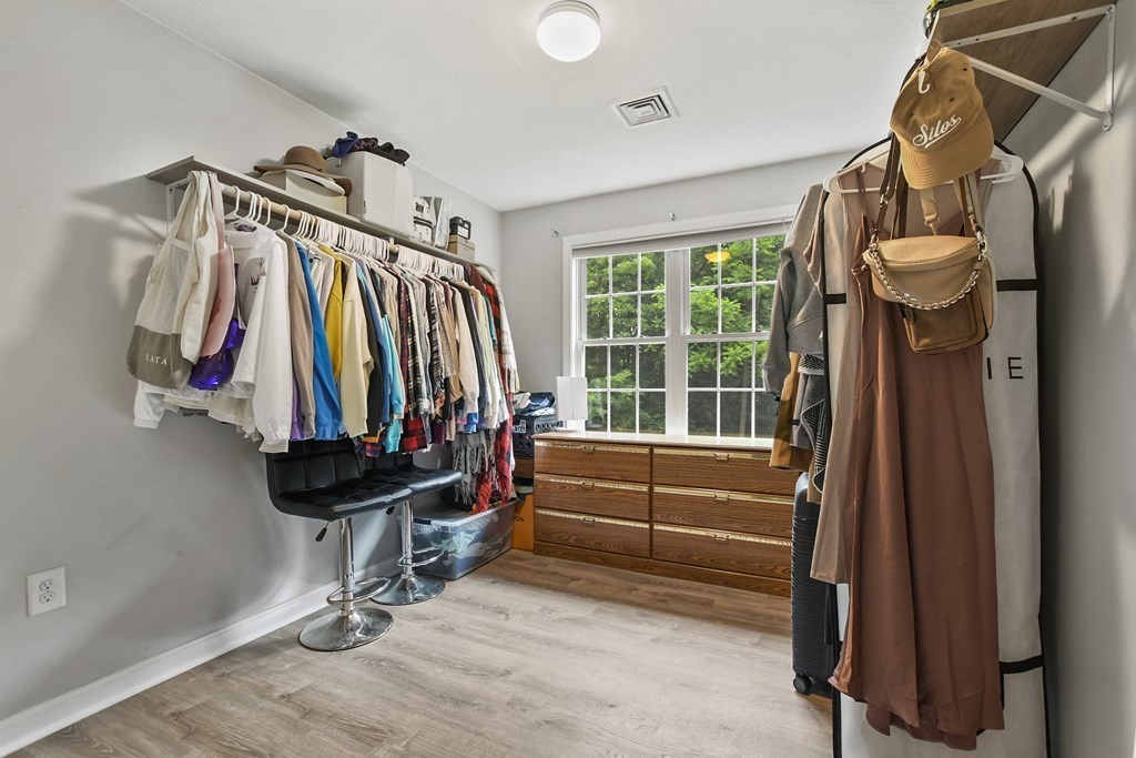305 North Main Street Raynham, MA 02767 - Photo 20 of 38 a view of walk in closet with clothes and shoes