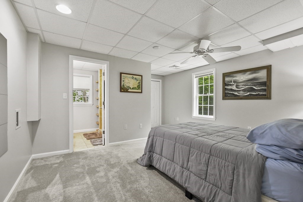 305 North Main Street Raynham, MA 02767 - Photo 26 of 38 a bedroom with a bed and a chandelier