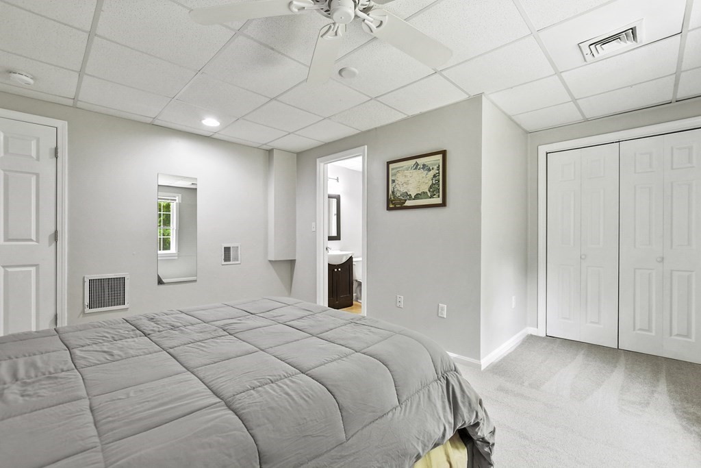 305 North Main Street Raynham, MA 02767 - Photo 29 of 38 a bedroom with a large bed and a chandelier