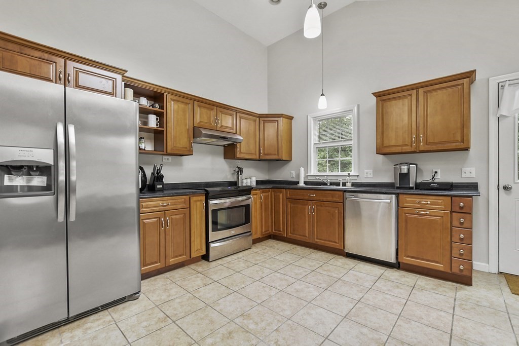 305 North Main Street Raynham, MA 02767 - Photo 9 of 38 a kitchen with stainless steel appliances granite countertop a refrigerator a stove a sink and dishwasher