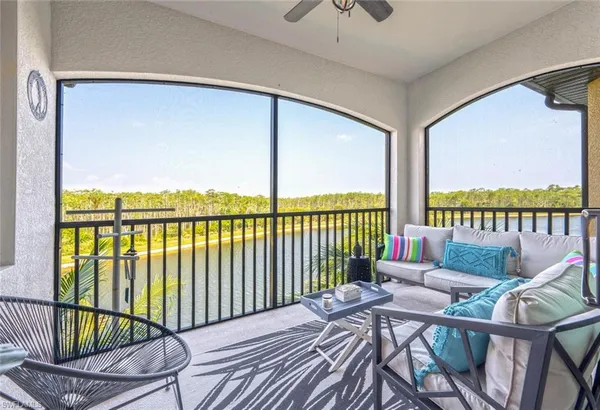 a balcony with furniture and wooden floor
