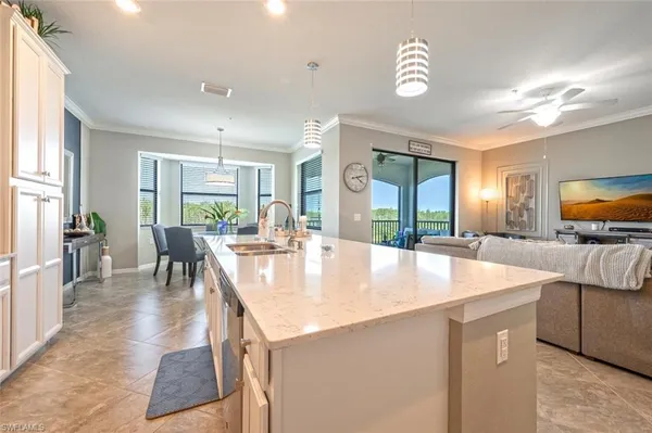 a large kitchen with kitchen island a large window