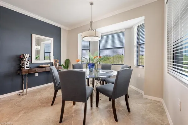 a dining room with furniture a chandelier and wooden floor