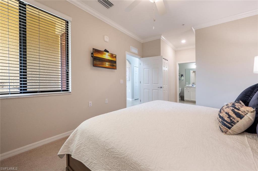 9572 Trevi Court, Unit 5045 Naples, FL 34113 - Photo 15 of 30 a spacious bedroom with a bed and a window