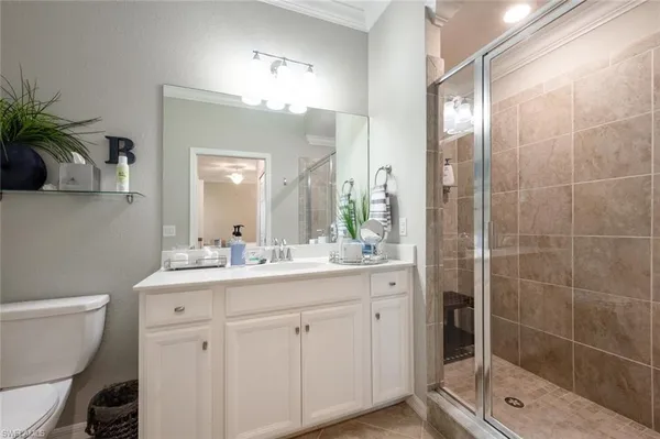 a bathroom with a double vanity sink toilet and shower