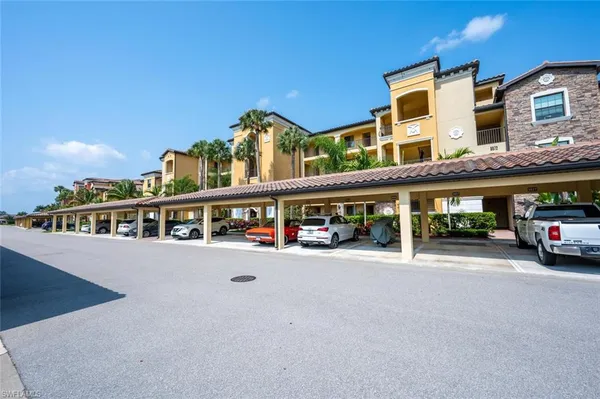 a view of a building with car parked