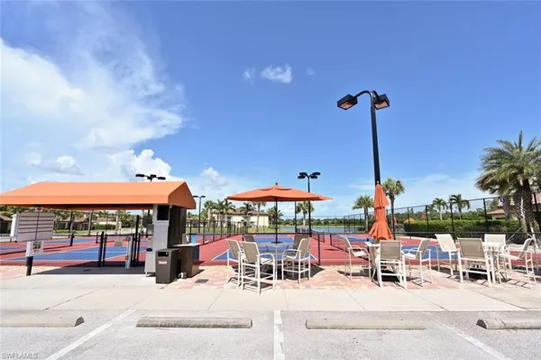 a view of a patio with a table and chairs under an umbrella