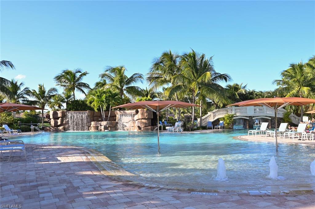 9572 Trevi Court, Unit 5045 Naples, FL 34113 - Photo 26 of 30 a front view of a house with a yard and garage
