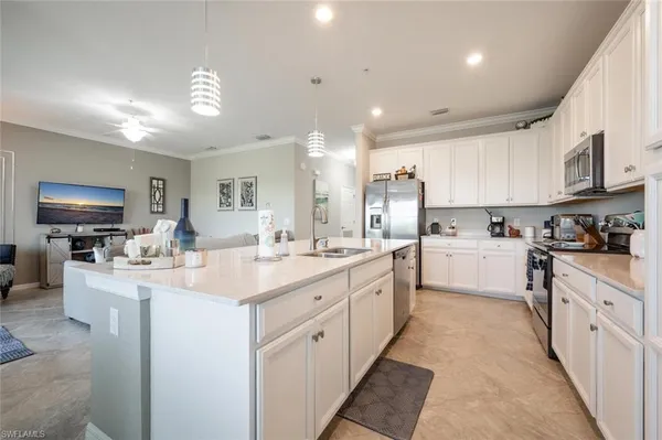 a kitchen with sink stove and refrigerator