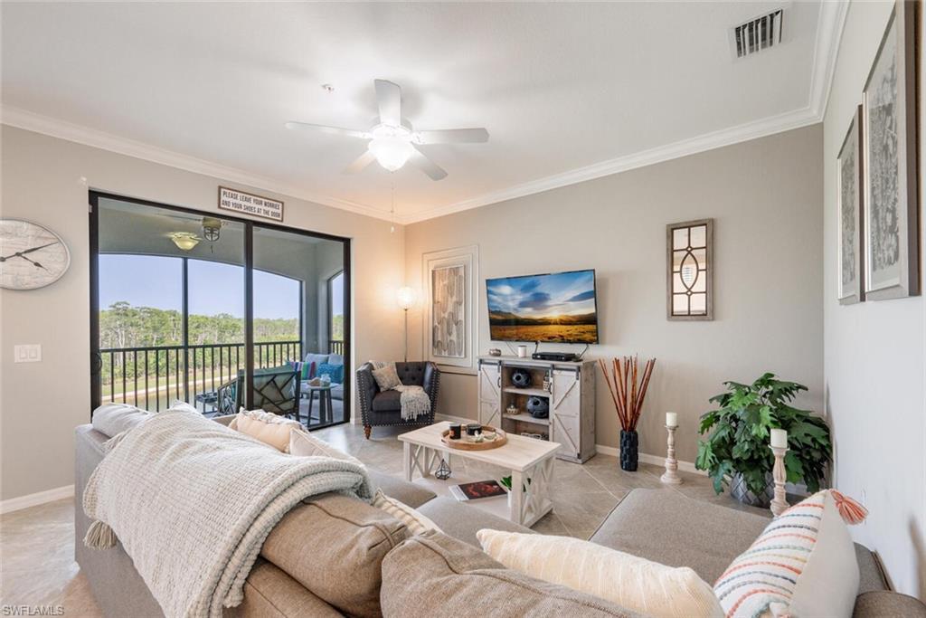 9572 Trevi Court, Unit 5045 Naples, FL 34113 - Photo 4 of 30 a living room with furniture and a flat screen tv