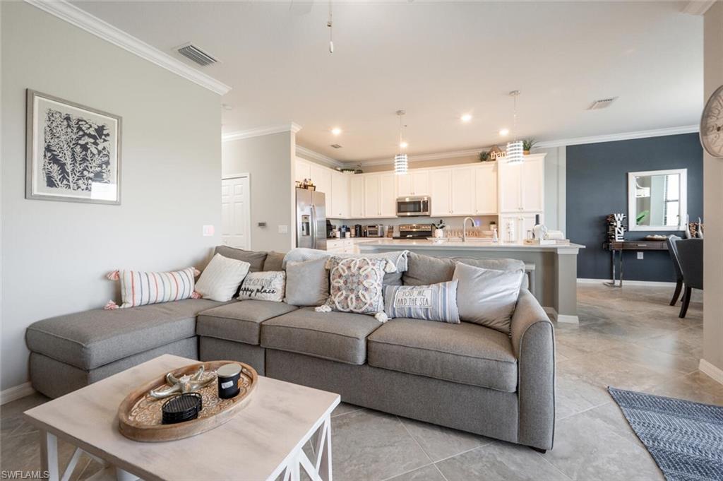 9572 Trevi Court, Unit 5045 Naples, FL 34113 - Photo 7 of 30 a living room with furniture and kitchen view
