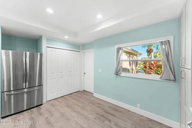 a view of a refrigerator in kitchen and wooden floor