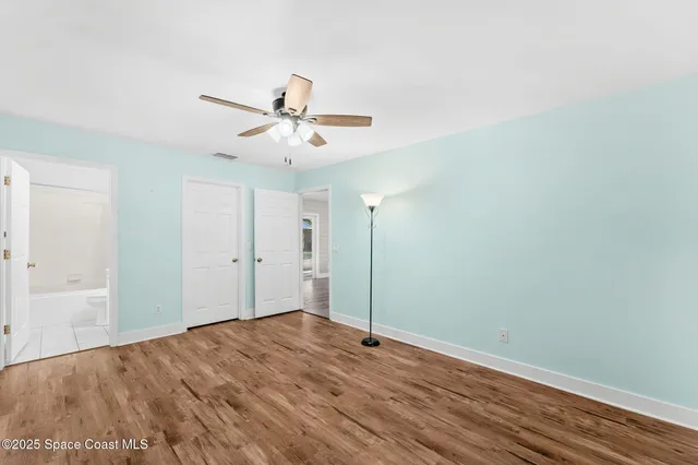 a view of a big room with wooden floor and closet area