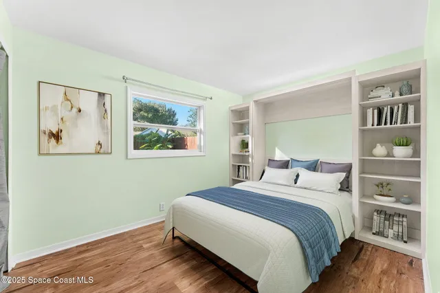 a bedroom with a large bed and a window