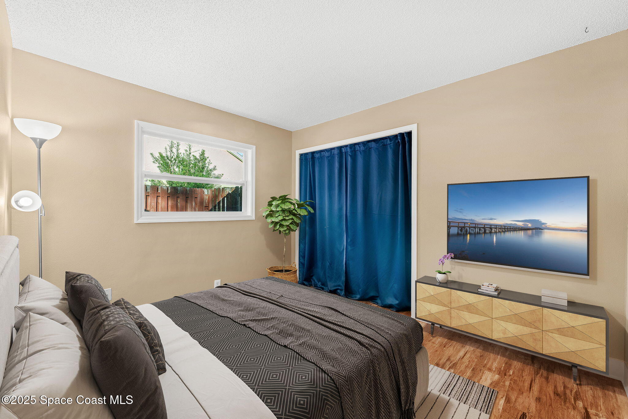 955 Sabal Grove Drive Rockledge, FL 32955 - Photo 21 of 39 a bedroom with a bed and a flat screen tv