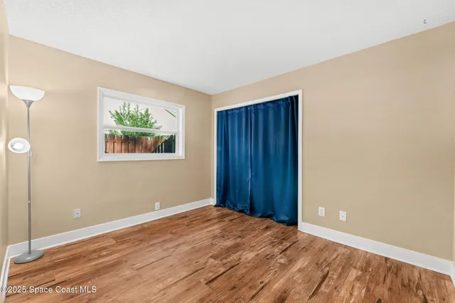 a view of wooden floor and windows in a room