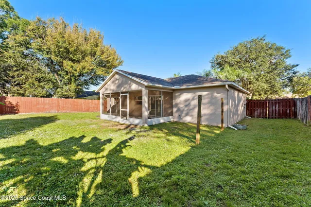 a swimming pool with lots of tress in front of it