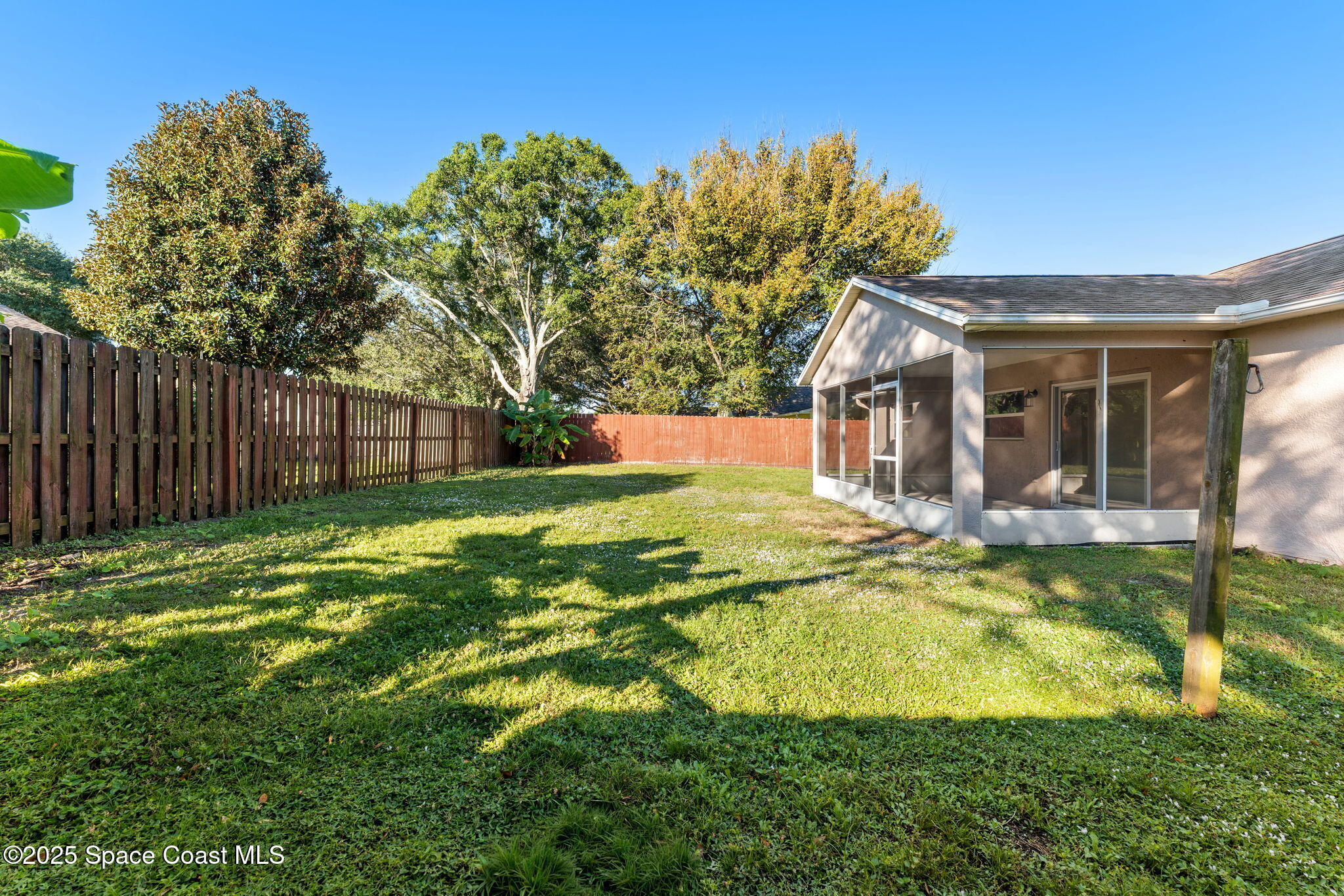 955 Sabal Grove Drive Rockledge, FL 32955 - Photo 29 of 39 a view of a house with pool and a small yard