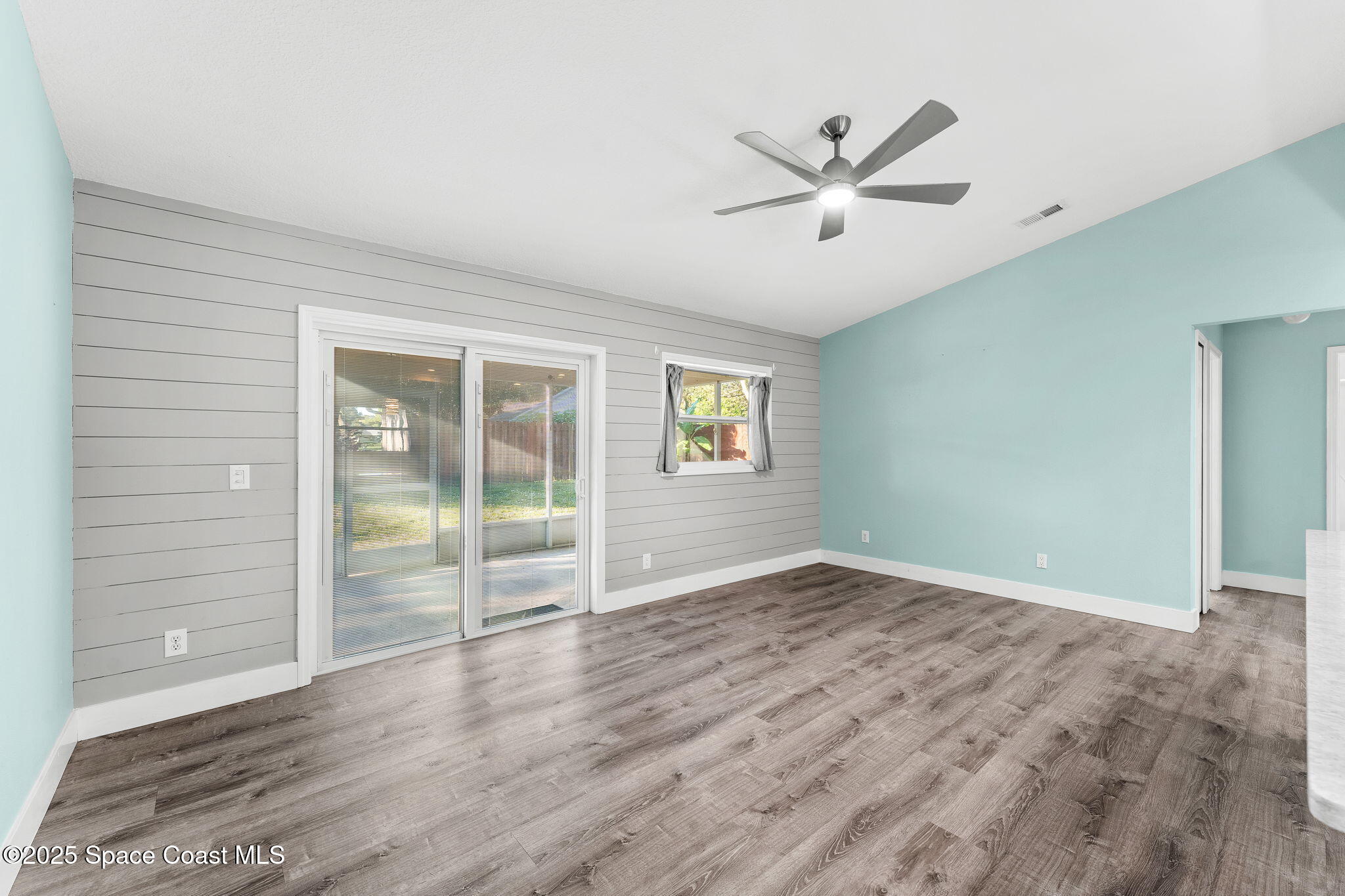 955 Sabal Grove Drive Rockledge, FL 32955 - Photo 5 of 39 wooden floor in an empty room with a window
