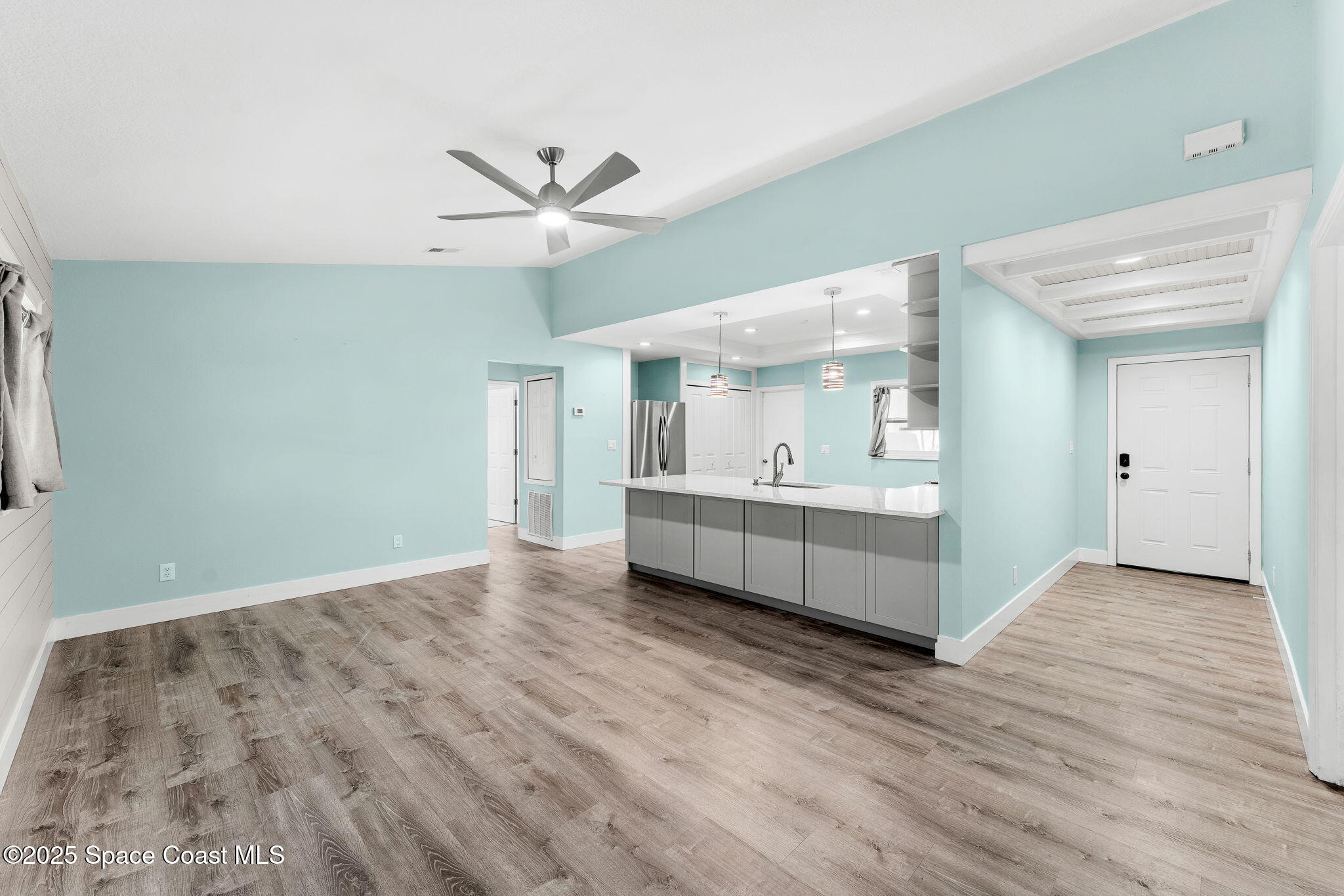 955 Sabal Grove Drive Rockledge, FL 32955 - Photo 6 of 39 a view of an empty room with a window and wooden floor