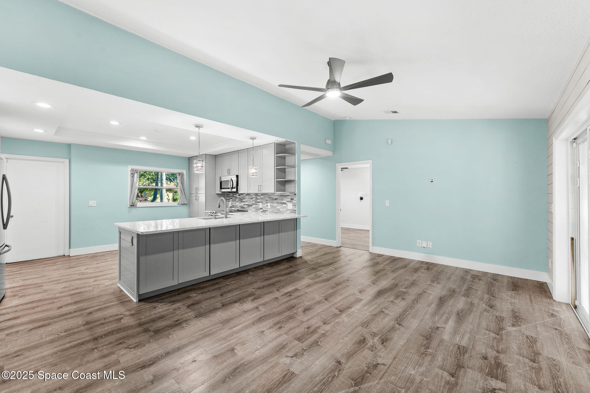 955 Sabal Grove Drive Rockledge, FL 32955 - Photo 7 of 39 a large white kitchen with a white countertops a sink and stainless steel appliances