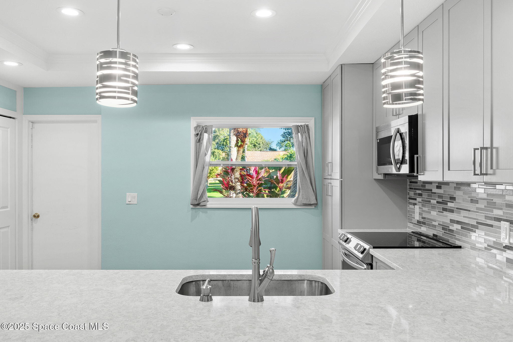 955 Sabal Grove Drive Rockledge, FL 32955 - Photo 8 of 39 a view of a kitchen with granite countertop a sink and chandelier