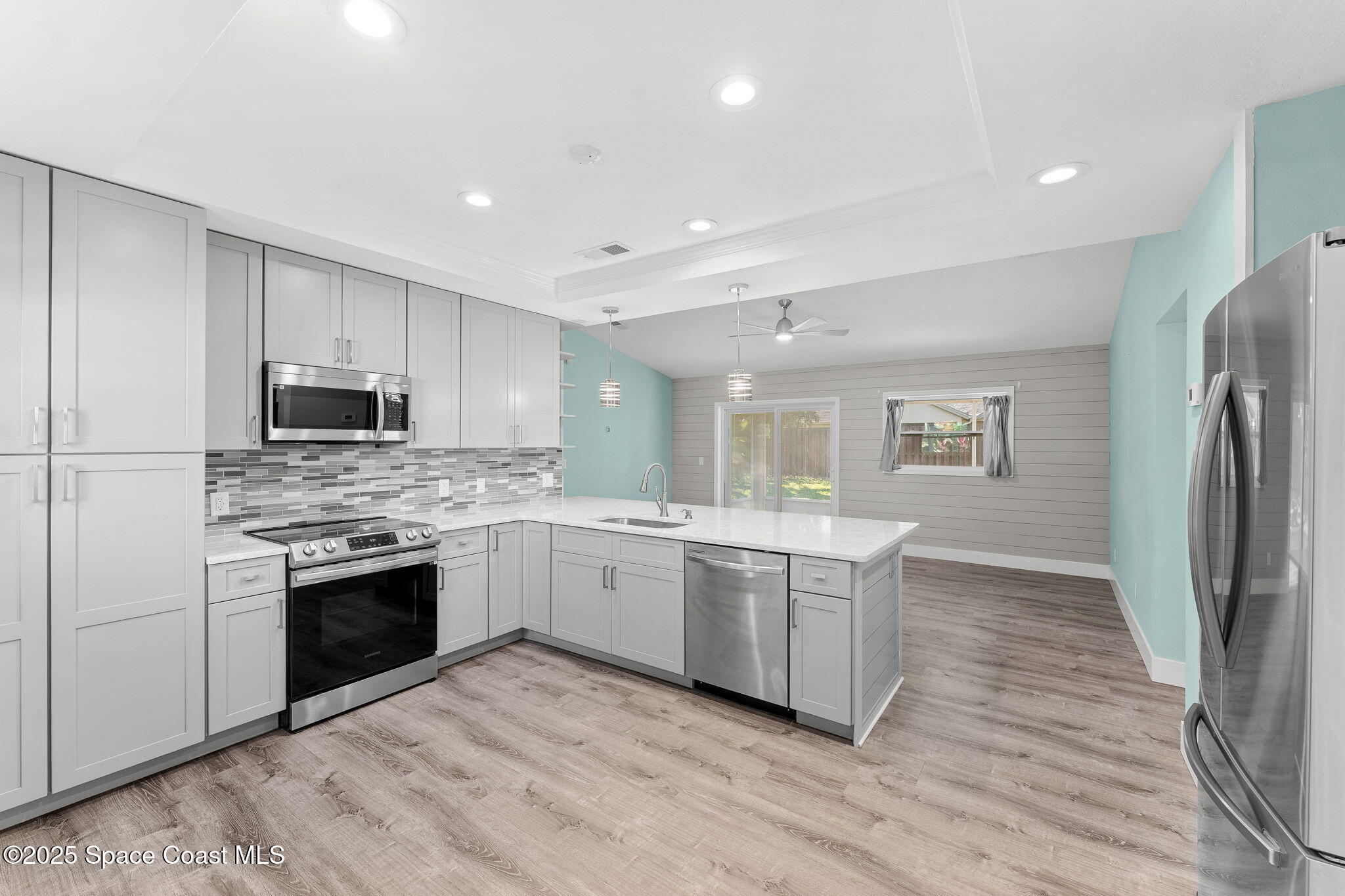 955 Sabal Grove Drive Rockledge, FL 32955 - Photo 10 of 39 a kitchen with stainless steel appliances granite countertop a stove and a refrigerator