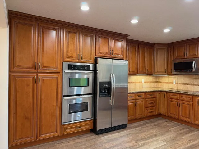 a kitchen with a refrigerator and cabinets