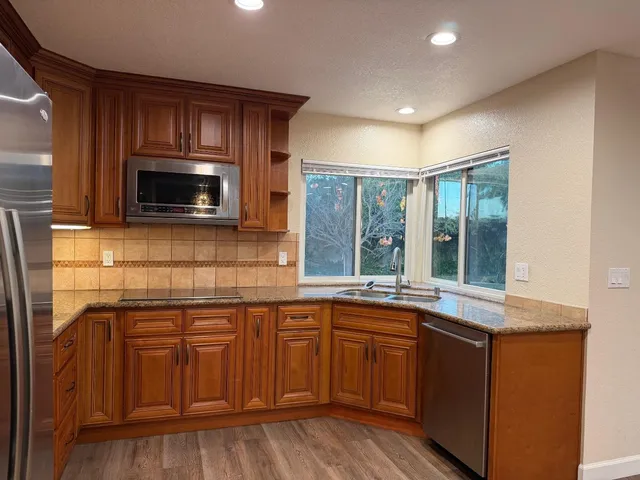 a kitchen with a sink cabinets and microwave