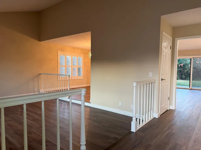 a view of staircase with wooden floor and fence