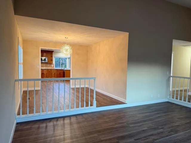 a view of wooden floor and a window in a room
