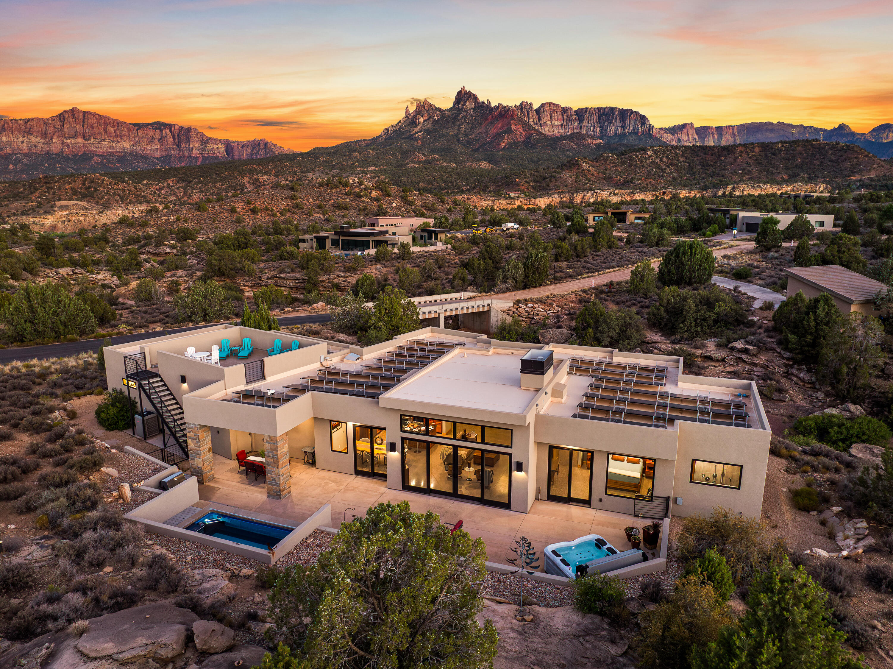 3000 Navajo Way Springdale, UT 84767 - Photo 3 of 63 Aerial at dusk with the home lit and the surrounding Anasazi Plateau homesites visible.
