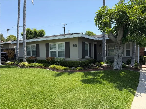 a front view of a house with garden and porch